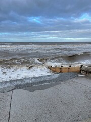 Canvas Print - Waves crashing onto the beach and sea wall during high tide. Taken in Cleveleys Lancashire England. 