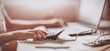 © candy1812 - Woman working with laptop and calculator at home office