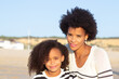 © KAMPUS - Portrait of serious African American family. Female models with curly hair and in striped pullovers looking at camera. Portrait, beauty concept