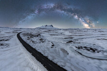 Long Asphalt Road Surrounded With Snow And Ice At Night In Iceland