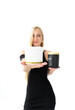 © neteli - A beautiful blonde girl with long even hair in a black dress holds jars for hair care in her hands Choice, macro, accent, plastic container, cometology, cosmetics, hair masks, medicine, care
