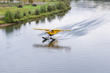 Bush float plane landing on  river in Alaska