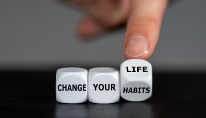 Wall Mural - Hand turns dice and changes the slogan 'change your habits' to 'change your life'.