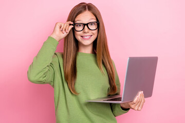 Poster - Photo of cheerful positive girl with straight hairdo green sweater fingers touch glasses hold laptop isolated on pink color background