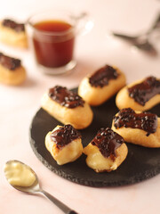 Wall Mural - Traditional French dessert - eclairs with a cup of coffee	