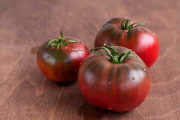 tomatoes on a wooden table. Close-up Fresh red tomatoes on brown background