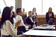 © Studio Romantic - Business people applaud cheers man on business meeting or training in bright modern office. Colleagues congratulate man clapping hands on business achievements, excellent work results or promotion.
