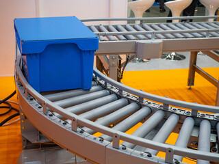Poster - Blue box on production line. Conveyor close-up. Storage equipment