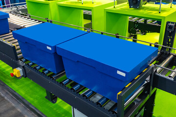 Poster - Boxes on conveyor. Steel conveyor line. Delivery fulfilment process. Distribution center. Working storage without people. Automated warehouse delivery service. Delivery service. Industrial conveyor.