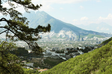 Canvas Print - Picturesque view of trees, buildings and mountains under beautiful sky in city