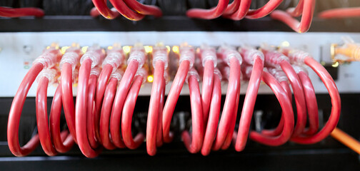 Fototapete - Technology, server room and cables connected to ethernet port or router for network, internet or fiber in data center for connection management. Electrical red optic cable for computer it background