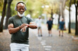 © M Einero/peopleimages.com - Music, time and running with a mature black man looking at his watch while out for a fitness run in the park. Workout, wellness and training with a senior male athlete or runner tracking his health