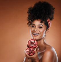 Pomegranate, Skincare And Portrait Of A Black Woman In Studio With Natural Facial Treatment. Health, Wellness And Young Model With Fruit For Skin, Face And Beauty Routine Isolated By Brown Background