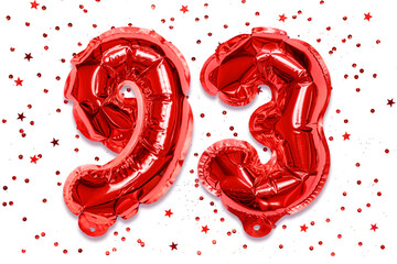 Wall Mural - The number of the balloon made of red foil, the number ninety-three on a white background with sequins. Birthday greeting card with inscription 93. Numerical digit. Celebration event.