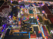 Aerial Top View Of Amusement Park In Night Temple Fair, And Night Local Markets. People Walking Street, Colorful Tents In Bangkok City, Thailand. Retail Shops