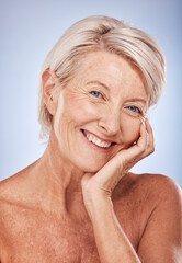 Portrait, cosmetics and senior woman with natural beauty, skincare and wellness for health on blue studio background. Makeup, mature lady or elderly female with smile, face detox and smooth skin care