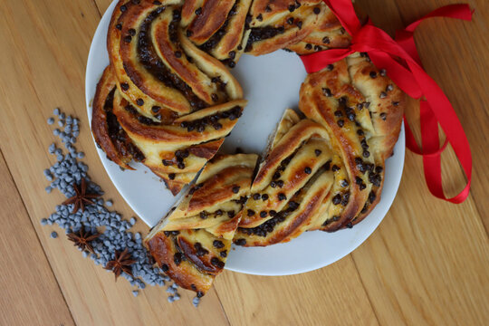 chocolate and orange jam braided brioche bread on a plate on wooden table