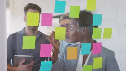 Wall Mural - Business people using post it notes to share ideas