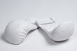 White boxing gloves for a child to practice karate or other martial arts.