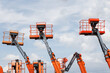 © Rattanachat - Mobile construction crane for rent and sale. Aerial work platforms of a cherry pickers with sky background. Boom lifting machine.