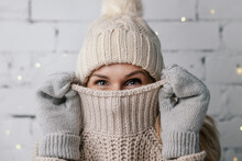 Woman Hiding Face In Wool Winter Sweater. Cold Weather Clothes