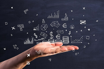 Poster - Close up of hand holding creative financial sketch on chalkboard background. Money, bank, commerce and investment concept.