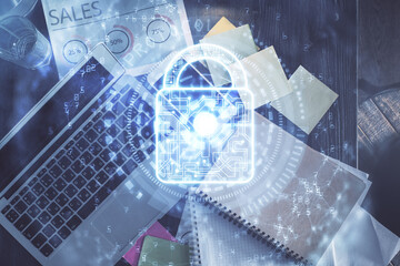 Poster - Double exposure of lock hologram drawing over study table background with computer. Concept of data security. Top view.