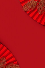 Paper fan symbol Chinese new year top view with copy space on red background