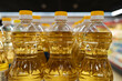 Yellow oil bottles (Soybean oil, Sunflower oil) selling on shelf at supermarket.