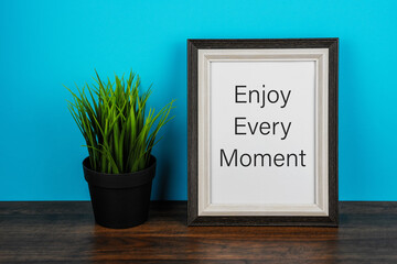 Wall Mural - Picture frame with inspirational text Enjoy every moment