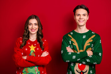 Canvas Print - Photo of two cheerful positive people toothy smile crossed arms isolated on red color background