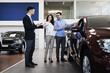 © Dusko - Middle age couple choosing and buying car at car showroom. Car salesman helps them to make right decision.