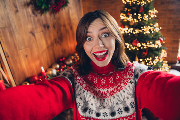 Wall Mural - Portrait of astonished cheerful person make selfie recording video enjoy festive time garland lights indoors