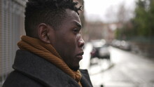 Concerned Black Man Standing Outside In City, Close-up Face Portrait Thoughtful Expression