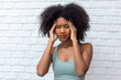 © kanpisut - Woman suffering from headache desperate and stressed because pain and migraine. Hand on head.