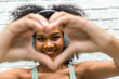 © kanpisut - Woman hold hands together in the shape of a heart. Woman show heart hand symbol