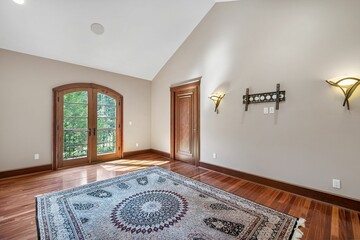 Poster - Empty room with a beautiful carpet, laminate flooring and white walls in a mansion