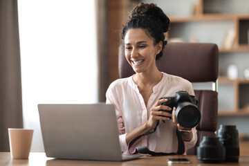 Wall Mural - Happy creative millennail woman photographer working at office studio