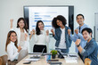 © amnaj - Group of young Asian businessmen are happy work together as a team and achieve goals excited about the work of raising hands to congratulate colleagues in the office.