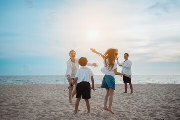 Wall Mural - Happy asian family on the beach in holiday. of the family play blowing bubble.They are having fun playing enjoying on the beach. Summer Family and lifestyle.