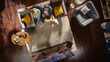 © Gorodenkoff - Top View of Apartment: Lovely Couple Watching Television in the Stylish Living Room. Looking at the TV Display and Eating Popcorn. Girlfriend and Boyfriend Watch Sitcom on Streaming Service on Couch.