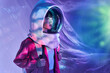 © ADDICTIVE STOCK - Calm woman in spacesuit helmet in neon light