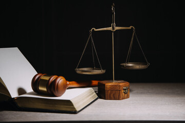 Justice and law concept.Male judge in a courtroom with the gavel, working with, computer and docking keyboard, eyeglasses, on table in morning light