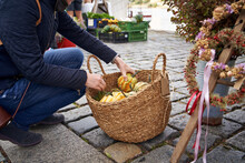 Woman Shopping For Gourds At The Farmers' Market In Autumn