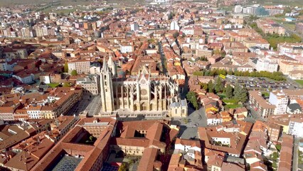 Wall Mural - Cinematic aerial view of European city Leon - SPAIN. Famous Cathedral of Leon, in the center of the city. Drone backward and tilt up creating a beautiful panorama of the city and landscape. 