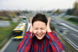 © zdravinjo - Woman with closed eyes covering her ears in the street while vehicles are passing by fast in the background. Stressful and frustrating situation. Noise pollution concept. Radial blur filter applied.