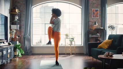 Wall Mural - Concentrated Positive Black Woman Doing Cardio, High Knees and Squat Exercises During Daily Workout at Cozy Home. Strong and Fit Girl Committing to Healthy Lifestyle. Fitness and Recreation Concept.