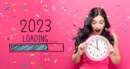 Poster - Loading new year 2023 with young woman holding a clock showing nearly 12