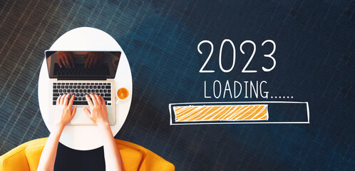 Poster - Loading new year 2023 with person using a laptop on a white table