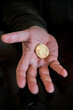 Hand holding and showing a golden Bitcoin,